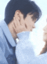 a man is touching a woman 's face with his hand .