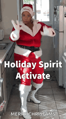 a woman dressed as santa claus in a kitchen with the caption holiday spirit activate