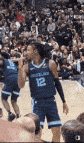 a basketball player wearing a grizzlies jersey stands on the court