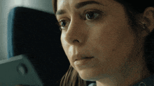a close up of a woman 's face with the letter o on her forehead
