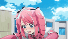 a girl with pink hair and blue eyes is standing in front of buildings