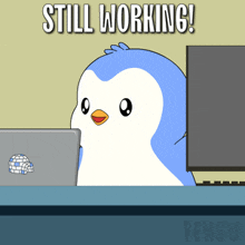 a penguin is sitting at a desk with a laptop and the words still working