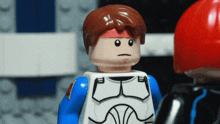 a lego man with a red headband on his head