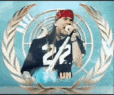 a man wearing a red bandana is singing into a microphone in front of a wreath .