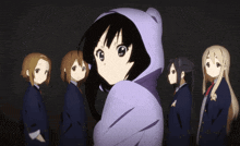 a group of anime girls are standing in a line with one wearing a purple hoodie
