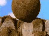 a large rock is sitting on top of a pile of rocks