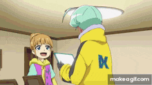 a man in a yellow jacket with an x on the back talks to a girl