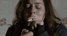 a woman is crying while smoking a cigarette with bbc on the bottom right