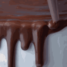 a close up of chocolate dripping from a piping tube