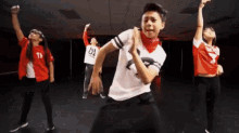 a group of young people are dancing on a stage .