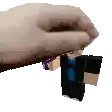 a pixel art of a hand holding a small minecraft figure .