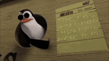 a penguin wearing sunglasses is standing next to a piece of paper with the number 6057 on it