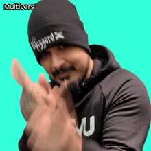a man wearing a beanie that says blizzard is clapping