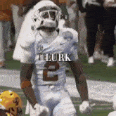 a football player wearing a number 2 jersey stands on the field