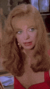 a close up of a woman 's face with blonde hair and blue eyes