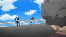 a group of people standing on top of a bridge looking at a person on a skateboard