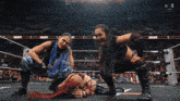 two women in a wrestling ring with the word raw on the bottom right