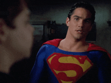 a man in a blue and red superman costume