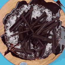 a donut with chocolate shavings and coconut on top of it