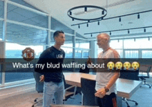 two men are talking in a conference room with a caption that says what 's my blud waffling about