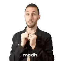 a man in a black jacket with the word mcdh on the bottom right