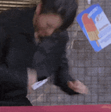 a man in a suit is standing next to a sign that says ' ice cream ' on it