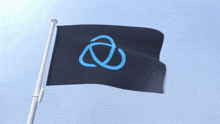 a black flag with a blue circle on it is waving in the wind