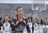 a group of cheerleaders are standing in front of a basketball hoop with the word university town on the bottom