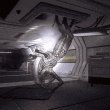 a statue of an alien hanging upside down in a dark room