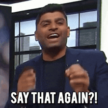 a man in a suit and black shirt says " say that again "