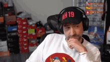a man wearing headphones and a hat that says ah19 on it