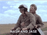 two men are riding on the back of a motorcycle with the words `` nash and jase '' written on the screen .
