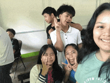 a girl wearing a shirt that says ' tomorrow ' on it poses for a photo