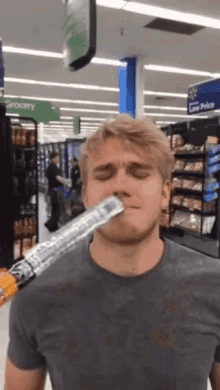 a man in a store with a sign that says grocery in the background