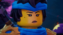 a lego figure with a blue scarf around his head