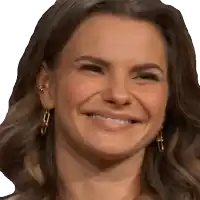 a close up of a woman 's face with a smile