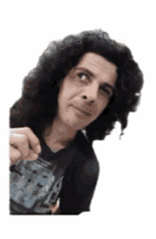 a man with long curly hair is peeking over a white wall .