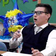 a man wearing glasses holds a sonic the hedgehog balloon