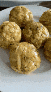 a white plate topped with a bunch of balls