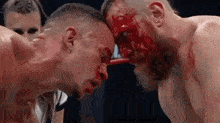 two men are standing next to each other with blood on their faces .