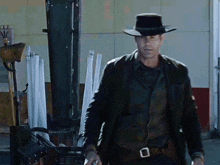 a man wearing a cowboy hat and a black jacket