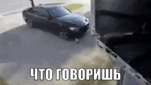 a car is driving down a street next to a building and a truck .