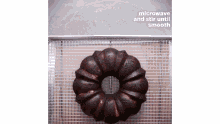 a bundt cake is sitting on a wire rack with the words microwave and stir until smooth