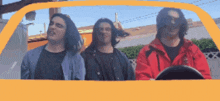 a group of men are sitting in a yellow car