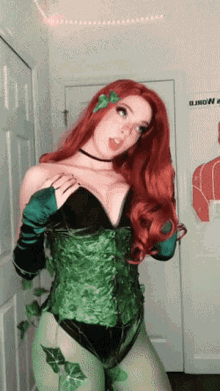 a woman in a poison ivy costume is standing in front of a door