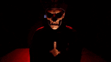 a skeleton in a military uniform is giving a thumbs up in a dark room