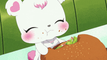 a teddy bear is eating a hamburger with lettuce and cheese