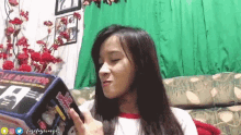 a girl is sitting on a couch reading a book called le detector .