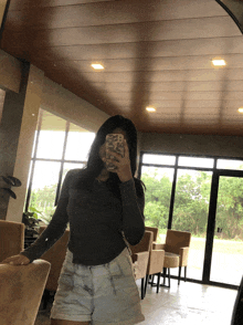 a woman taking a picture of herself with her phone