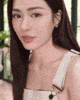 a close up of a woman 's face wearing overalls